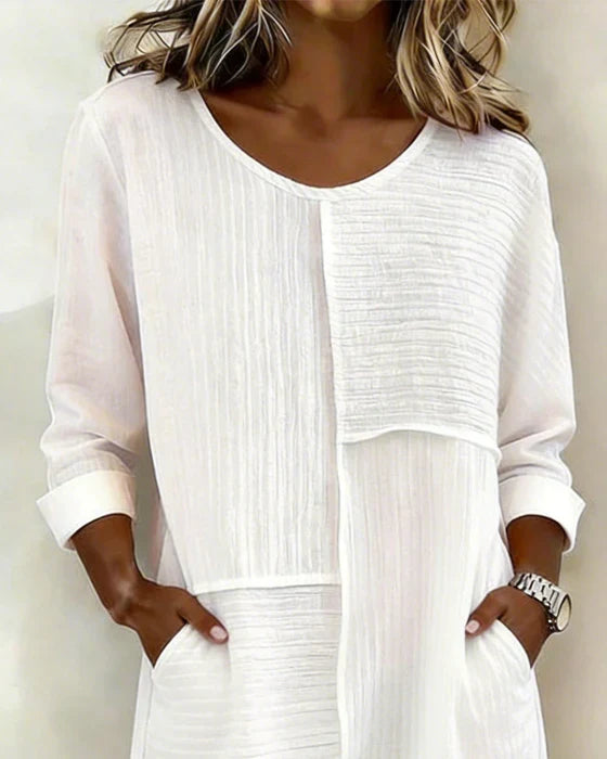 Elegant women's textured shift dress, relaxed fit with pockets, ideal for summer casual wear.
