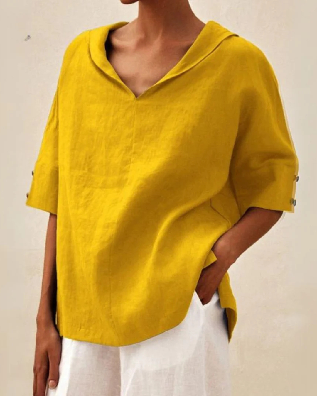 Model wearing a relaxed fit V-neck short sleeve blouse, perfect casual comfort top for everyday fashion.