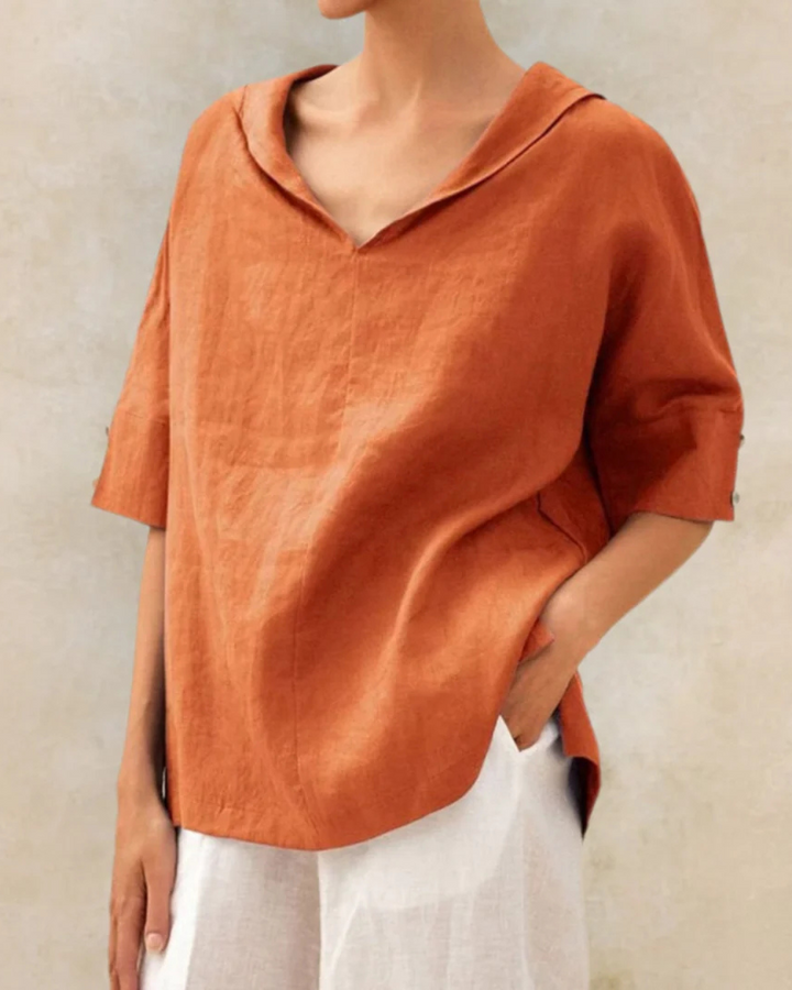 Close-up of soft fabric on a women's relaxed V-neck short sleeve blouse, emphasizing comfortable daily wear.