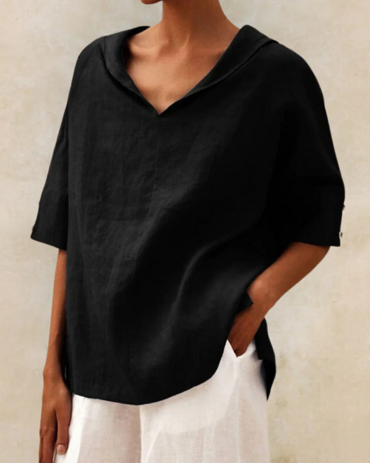 Back view of a women's relaxed V-neck short sleeve blouse, showcasing comfortable fit for versatile daily wear.