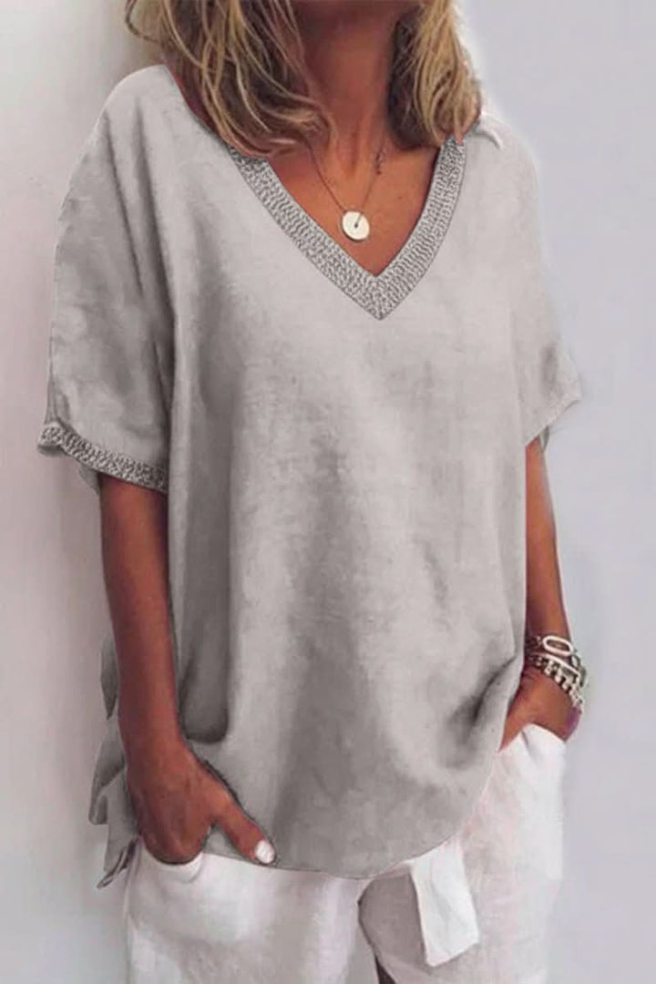 Comfortable women's V-neck blouse, relaxed fit and lightweight, perfect for casual summer fashion.