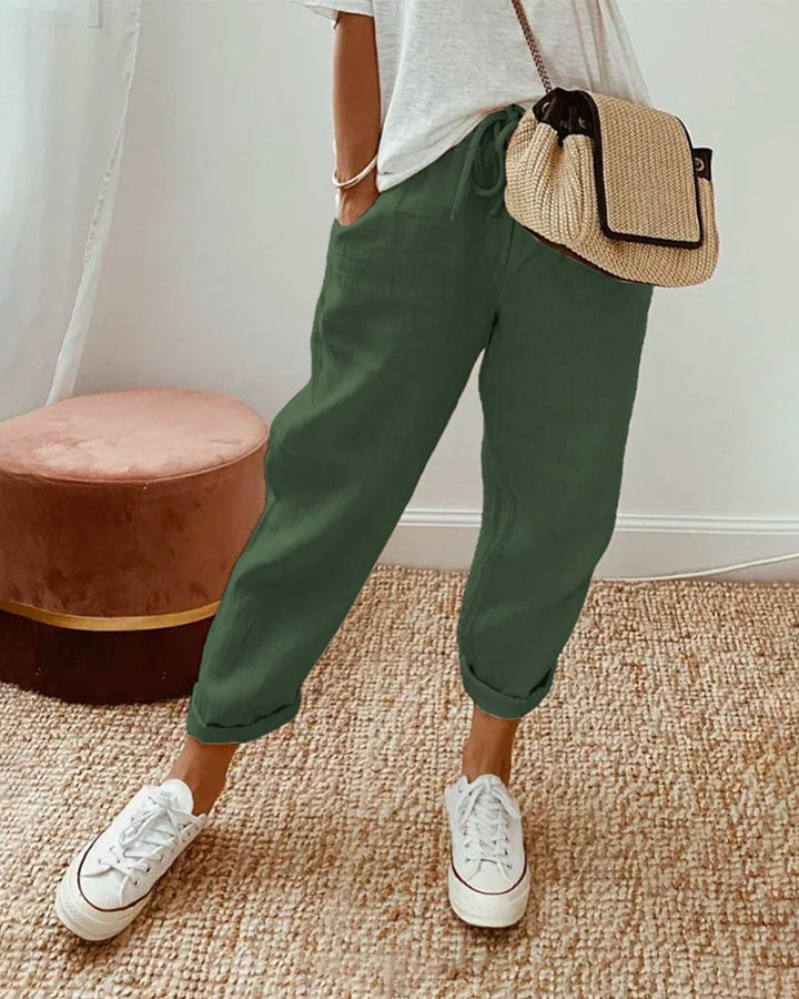 Relaxed fit women's linen jogger pants with an adjustable drawstring waist & chic roll cuff, perfect for summer comfort.