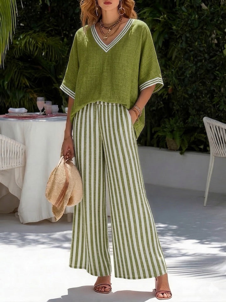 Chic women's striped two-piece set, featuring a relaxed shirt and flowy wide-leg pants for summer.