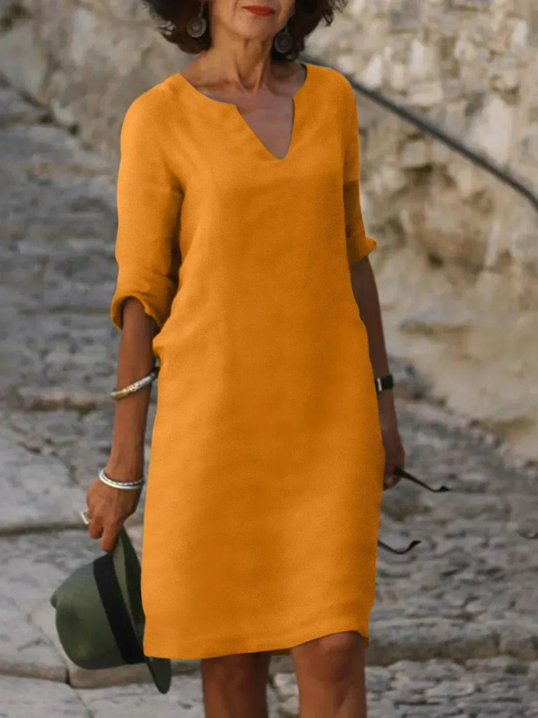 Easy-wear women's relaxed V-neck midi dress, 3/4 sleeves. Chic travel wear, comfortable for day or evening.