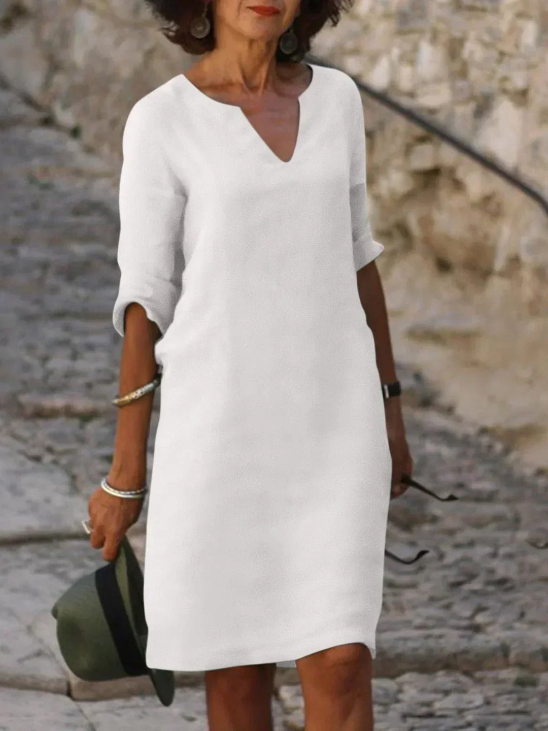 Relaxed V-neck midi dress for women, 3/4 sleeves. Chic and versatile for day, evening, and comfortable travel.
