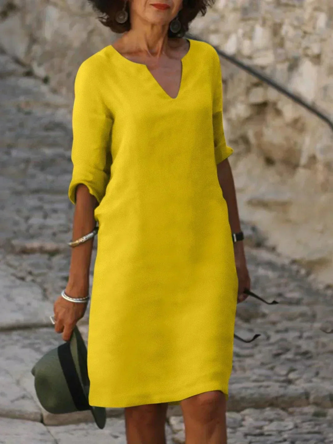 Women's relaxed V-neck midi dress with 3/4 sleeves and pockets. Comfortable, casual, and elegant for any day.