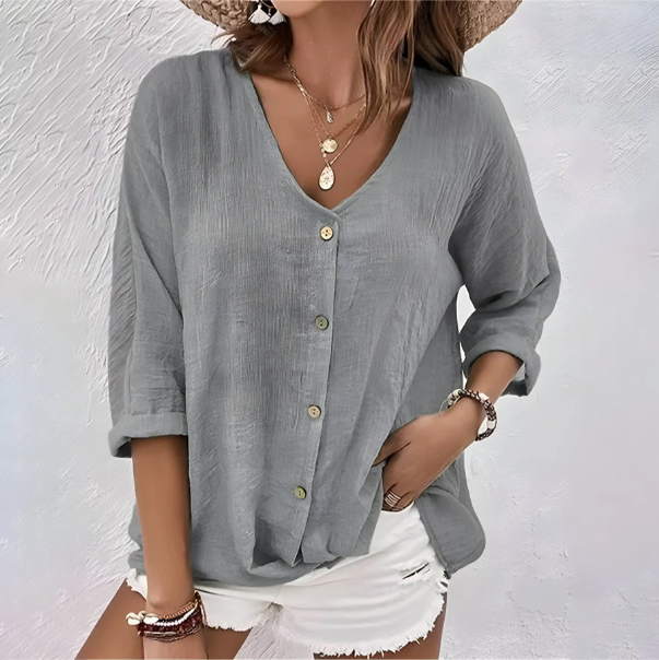 Stylish women's V-neck roll sleeve button-down blouse with a relaxed fit. Perfect casual summer wear.