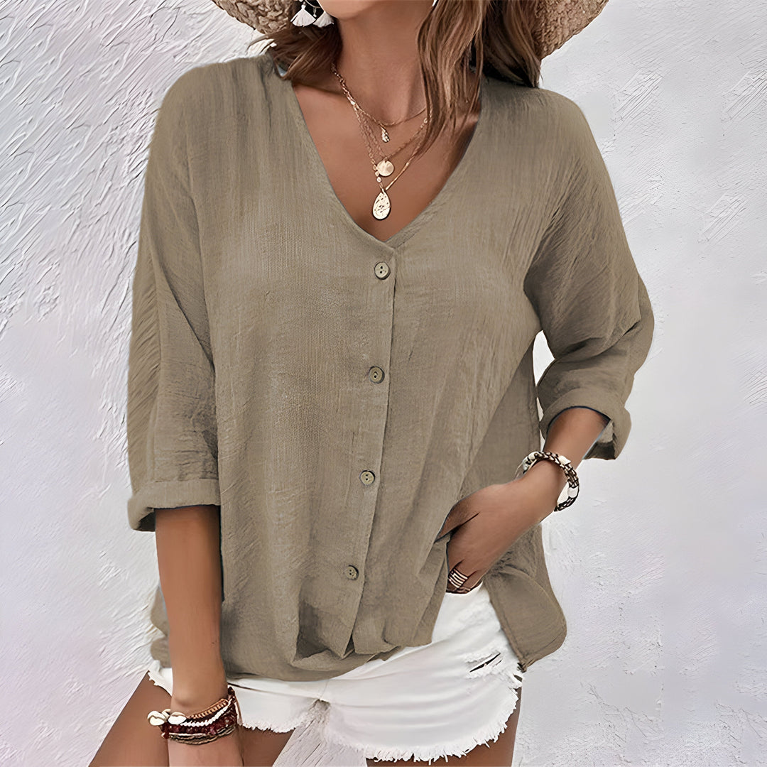Relaxed fit women's button-down V-neck blouse with roll sleeves. A comfortable and fashionable summer top.