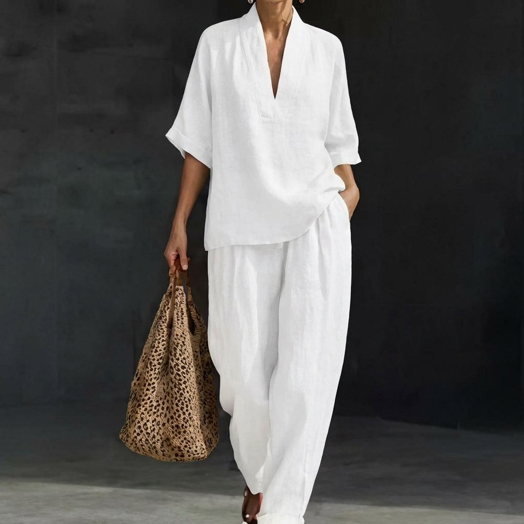 Stylish women's relaxed 2-piece set. V-neck top & wide-leg pants deliver comfortable, modern summer style.