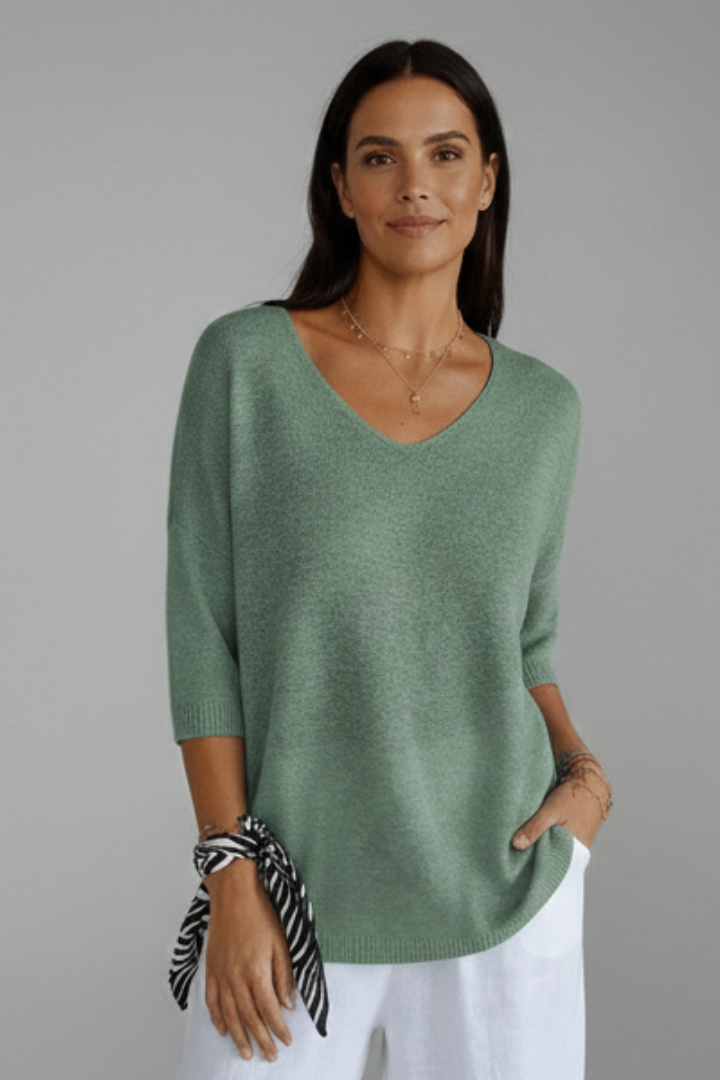 Fashionable women's pullover V-neck top, relaxed fit elbow sleeve for versatile casual outfits.