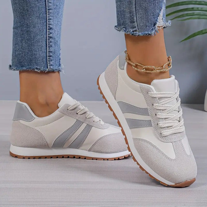 Women's retro lace-up sneakers, perfect for casual everyday wear. Comfortable low-top design with stylish striped details.