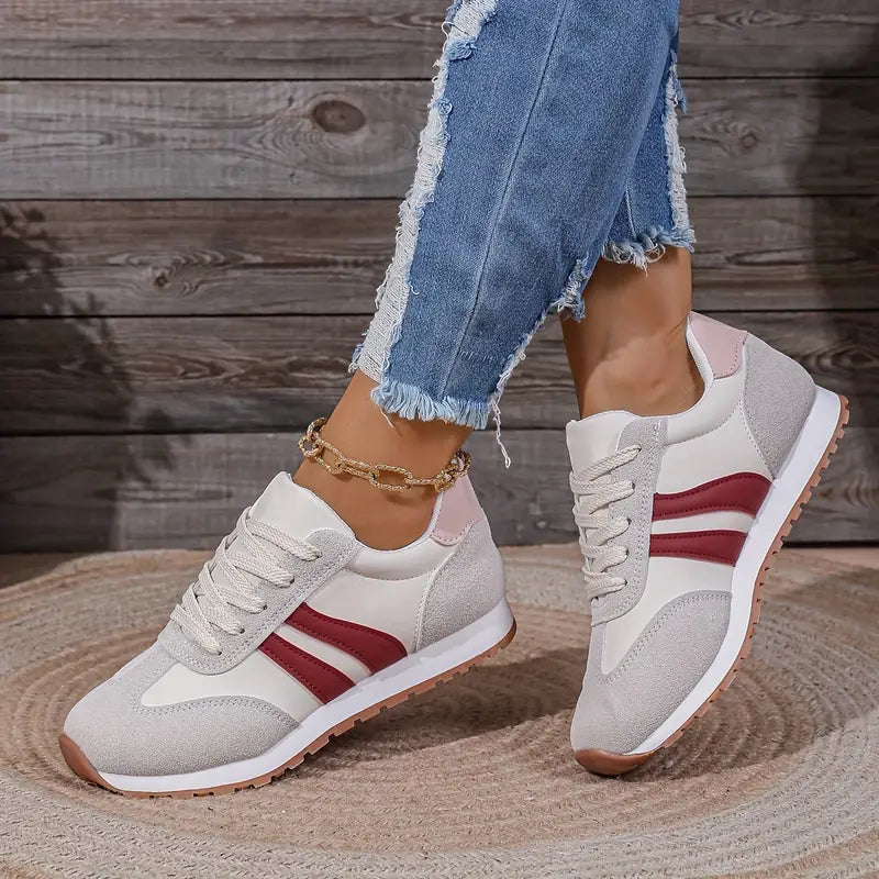 Trendy women's fashion sneakers with lace-up closure. Versatile low-top design for comfortable everyday wear and stylish outfits.