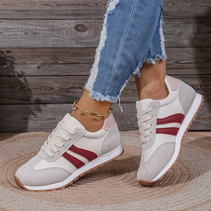 Trendy women's fashion sneakers with lace-up closure. Versatile low-top design for comfortable everyday wear and stylish outfits.