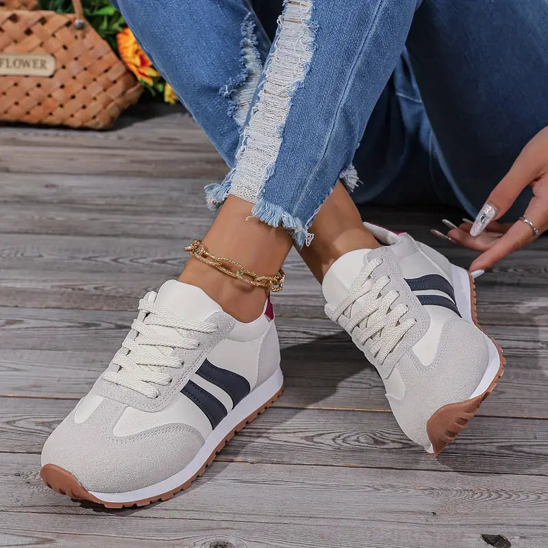 Stylish women's lace-up retro sneakers featuring a striped design. Comfortable low-top ladies' footwear for versatile fashion.