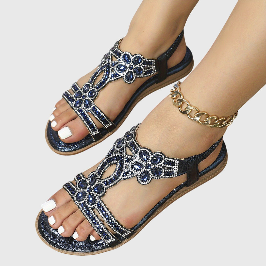 Bohemian women's flat sandals with shiny rhinestone and gemstone accents.