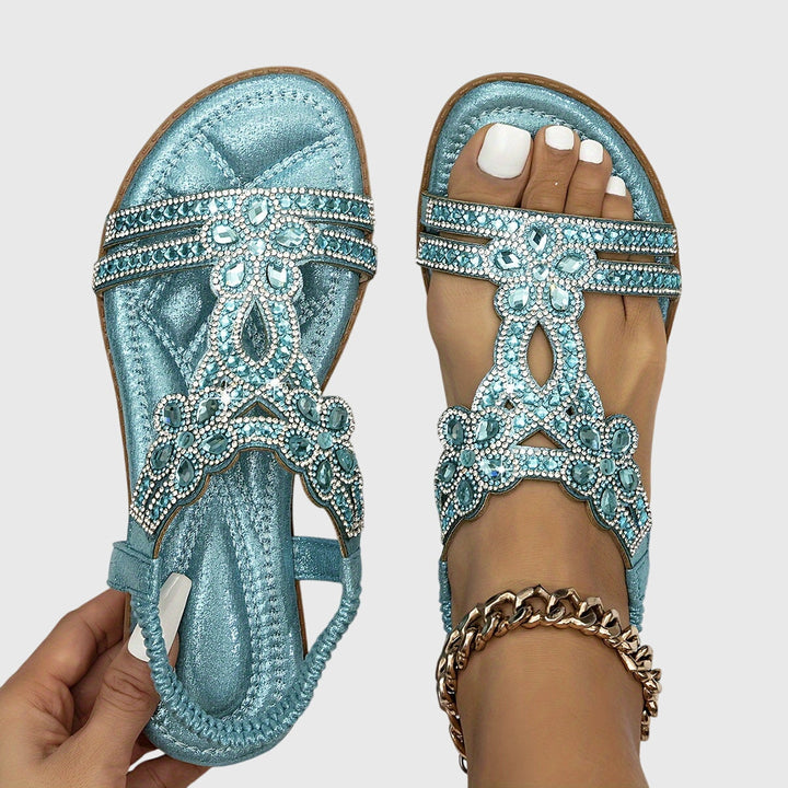 Glamorous women's flat sandals with sparkling rhinestones for resort wear.