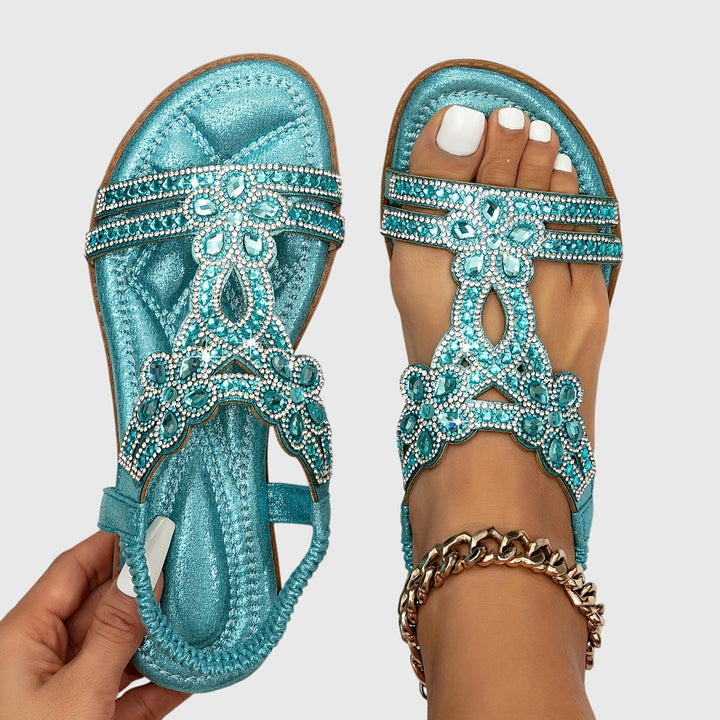 Glamorous women's flat sandals with intricate rhinestone details, perfect for any occasion.