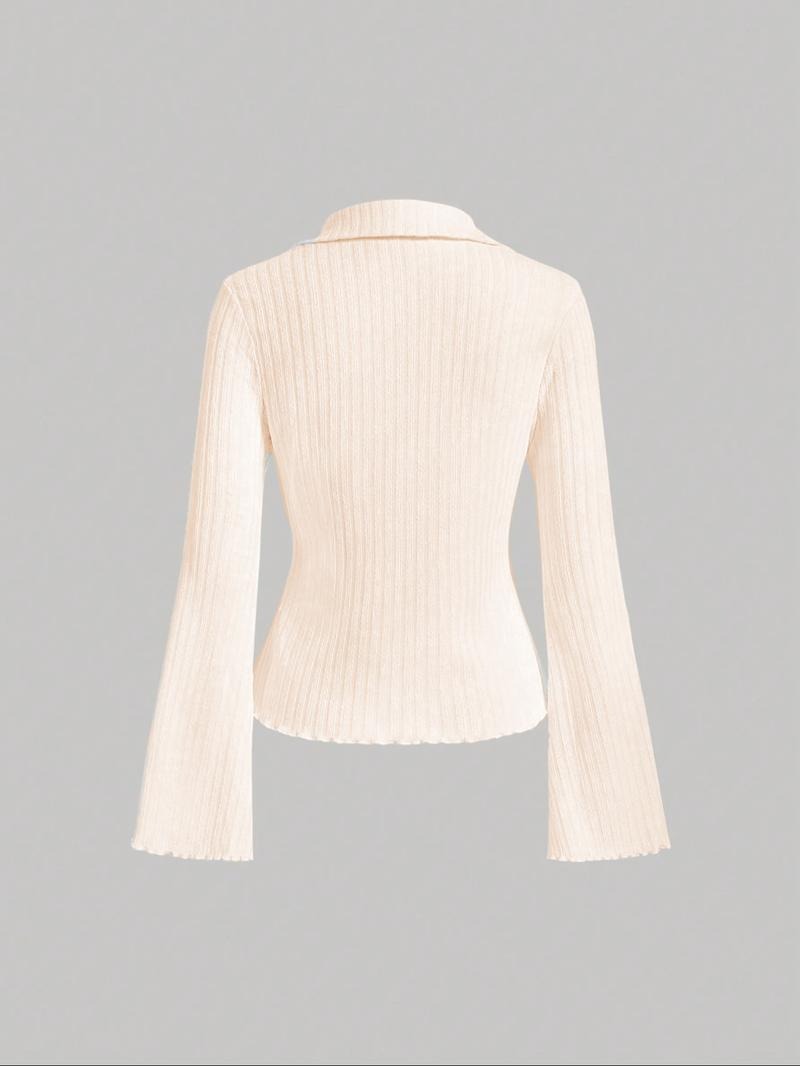 Stylish women's ribbed knit blouse with flattering flared sleeves. Perfect for casual or elegant occasions. Navy blue.