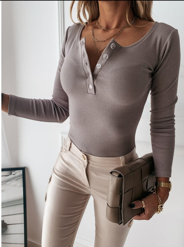 Elegant women's long sleeve ribbed top with a button-front design, suitable for stylish autumn and winter outfits.