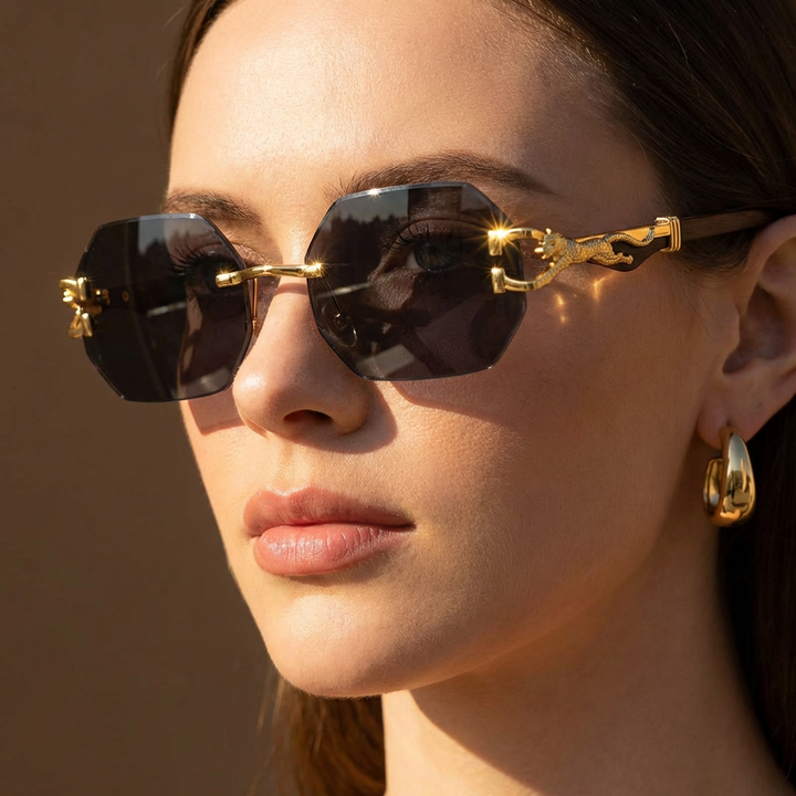 Statement women's rimless geometric sunglasses. Trendy fashion accessory with elegant gold panther detail.