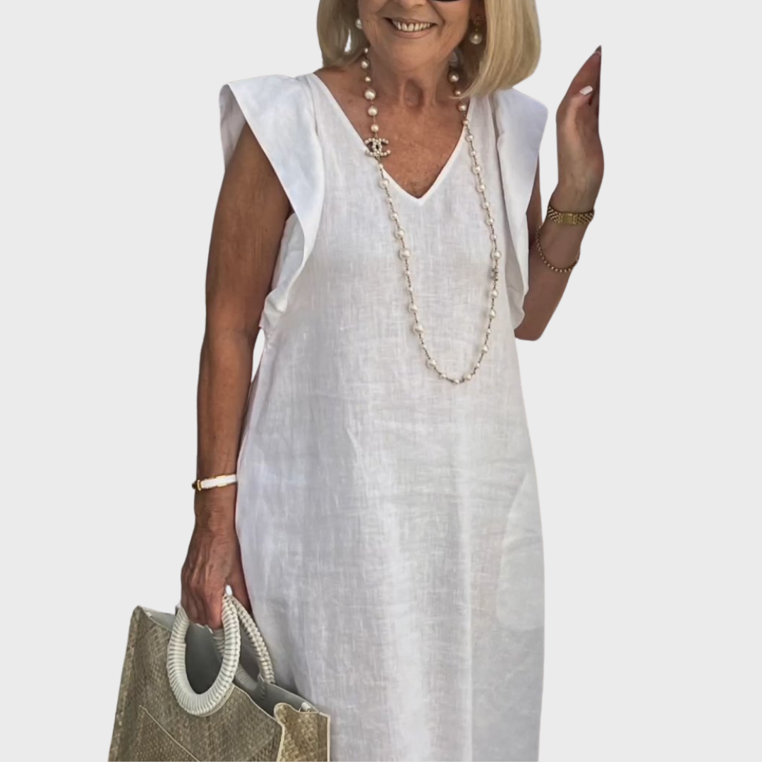 Flowy V-neck sleeveless maxi dress with ruffle shoulders & pockets, ideal for comfortable resort wear & vacation.