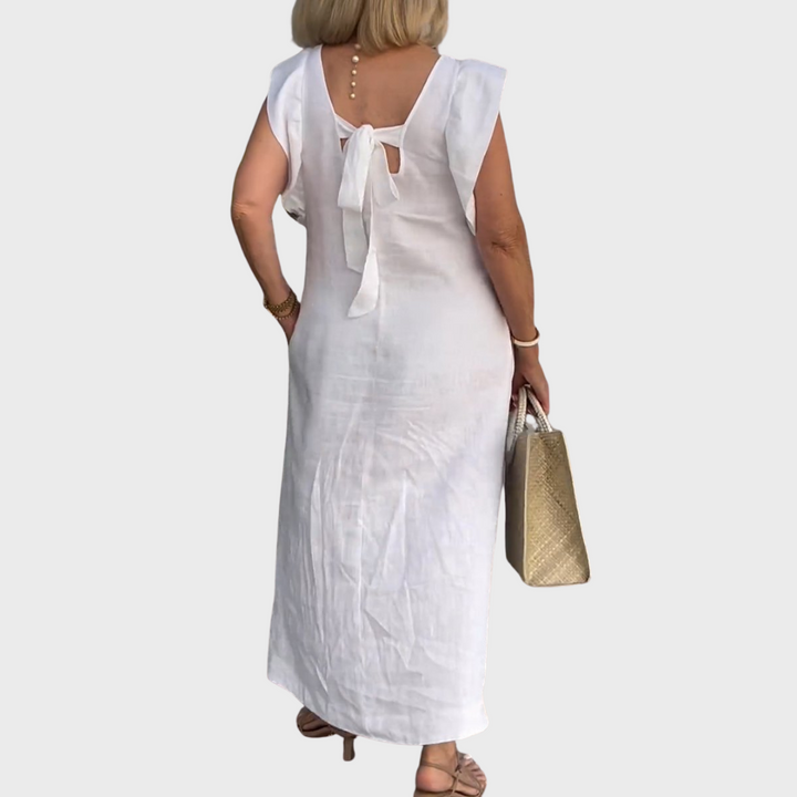 Sleeveless V-neck maxi dress with stylish ruffle shoulders & practical pockets, a versatile summer fashion choice.