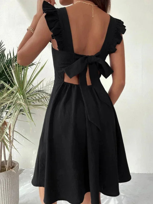 Charming women's summer mini dress with delicate ruffle straps, A-line fit, and a playful bow back.