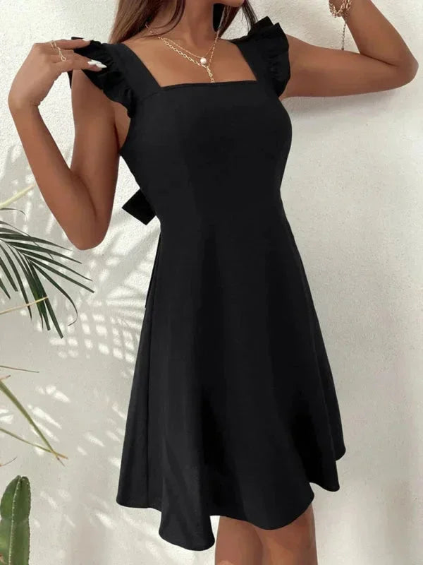 Flirty A-line mini dress for women, with stylish ruffle straps and an adorable bow detail at the back.