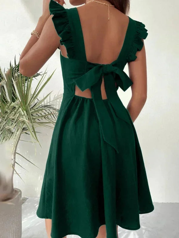 Chic women's mini dress: ruffle straps, A-line silhouette, and a stylish bow back. Versatile summer wear.