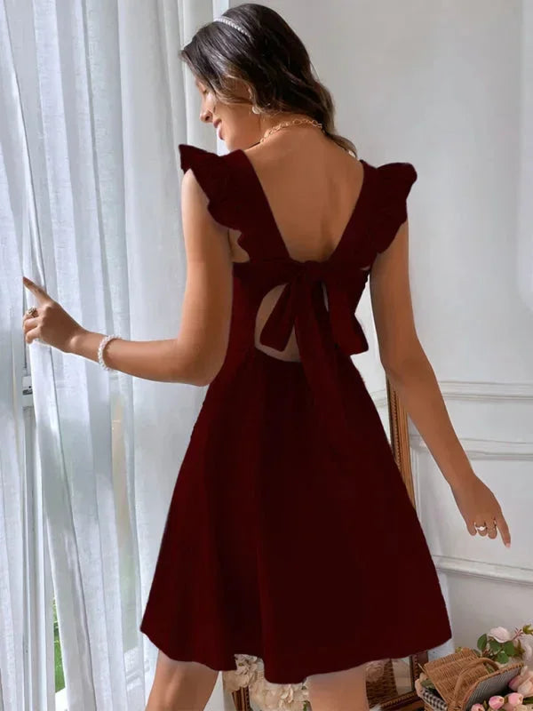 Flattering A-line mini dress, perfect for women, with pretty ruffle straps and a cute back bow.