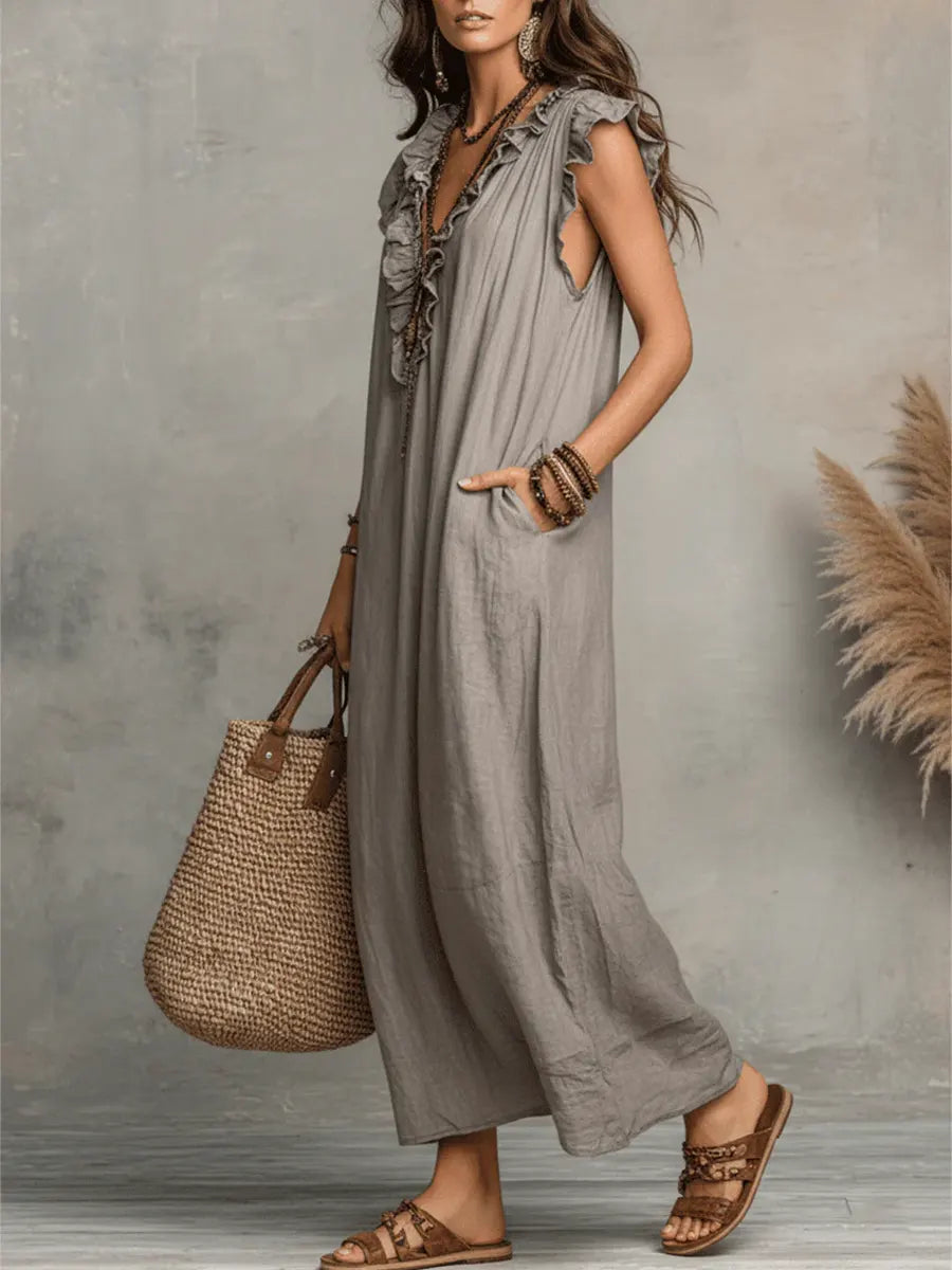 Vacation-ready women's V-neck ruffle maxi dress with flowy flutter sleeves and convenient side pockets.
