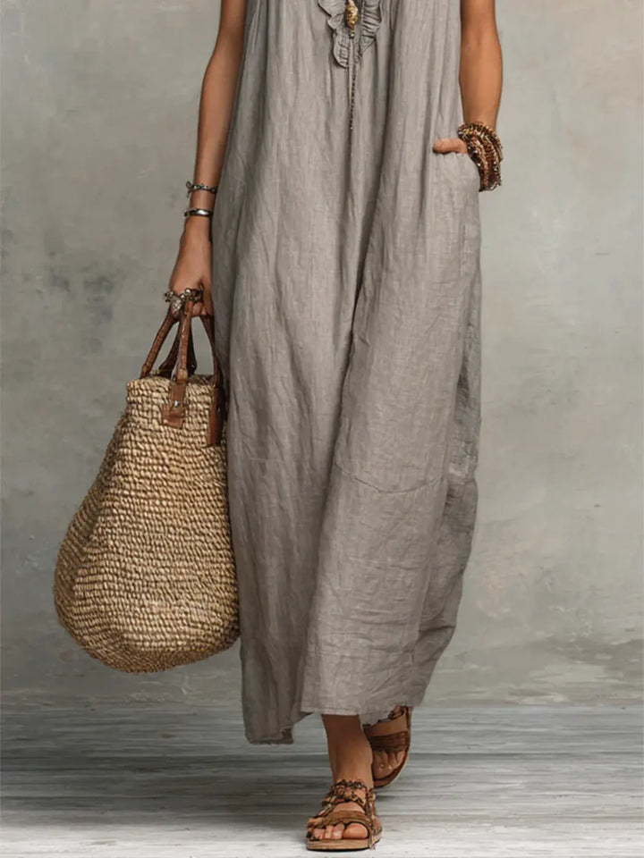 Flowy women's maxi dress featuring a V-neck, delicate flutter sleeves, playful ruffles, and discreet pockets.