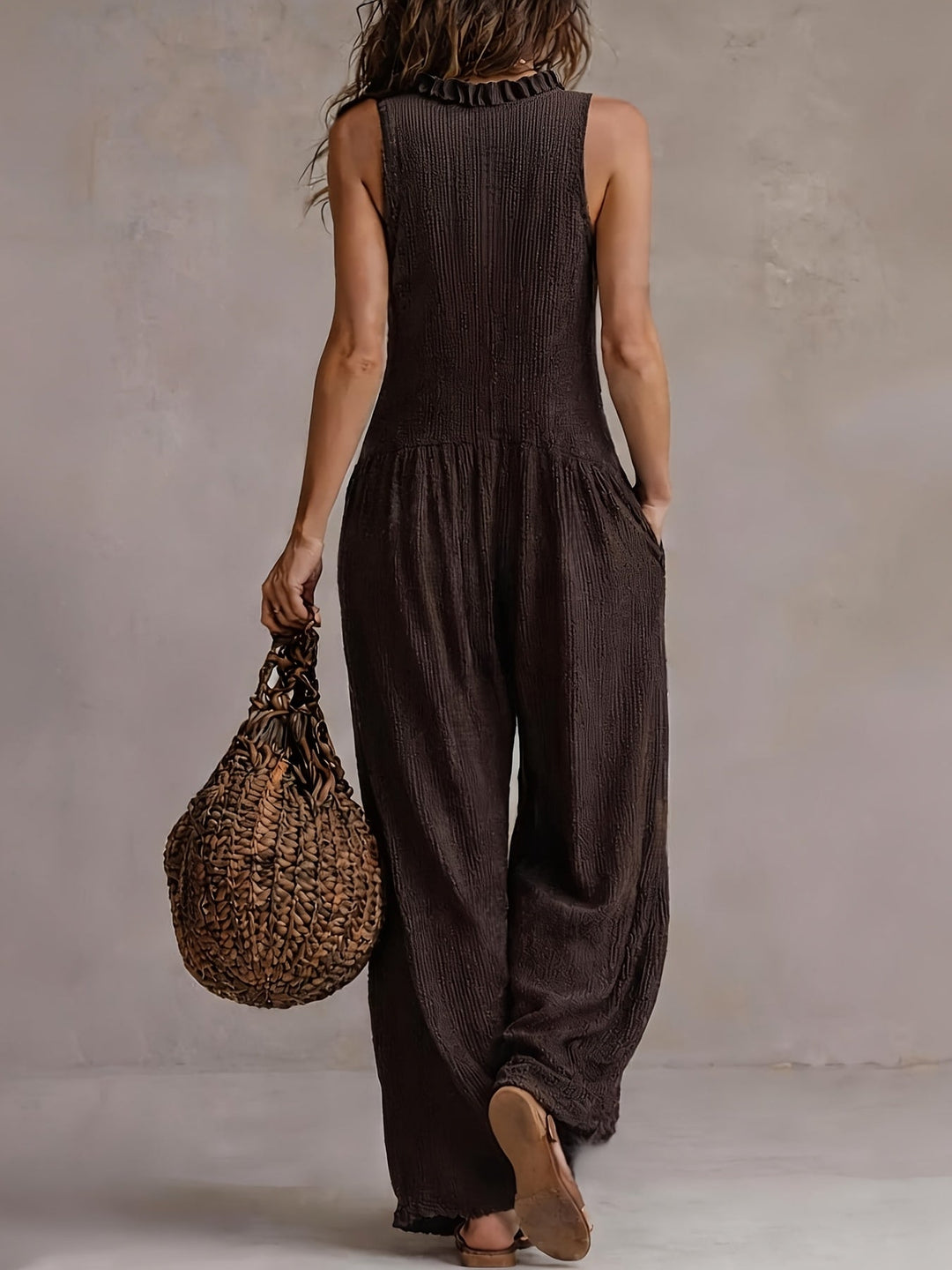 Stylish women's jumpsuit featuring a ruffle V-neck, smocked waist, and flowy wide legs.