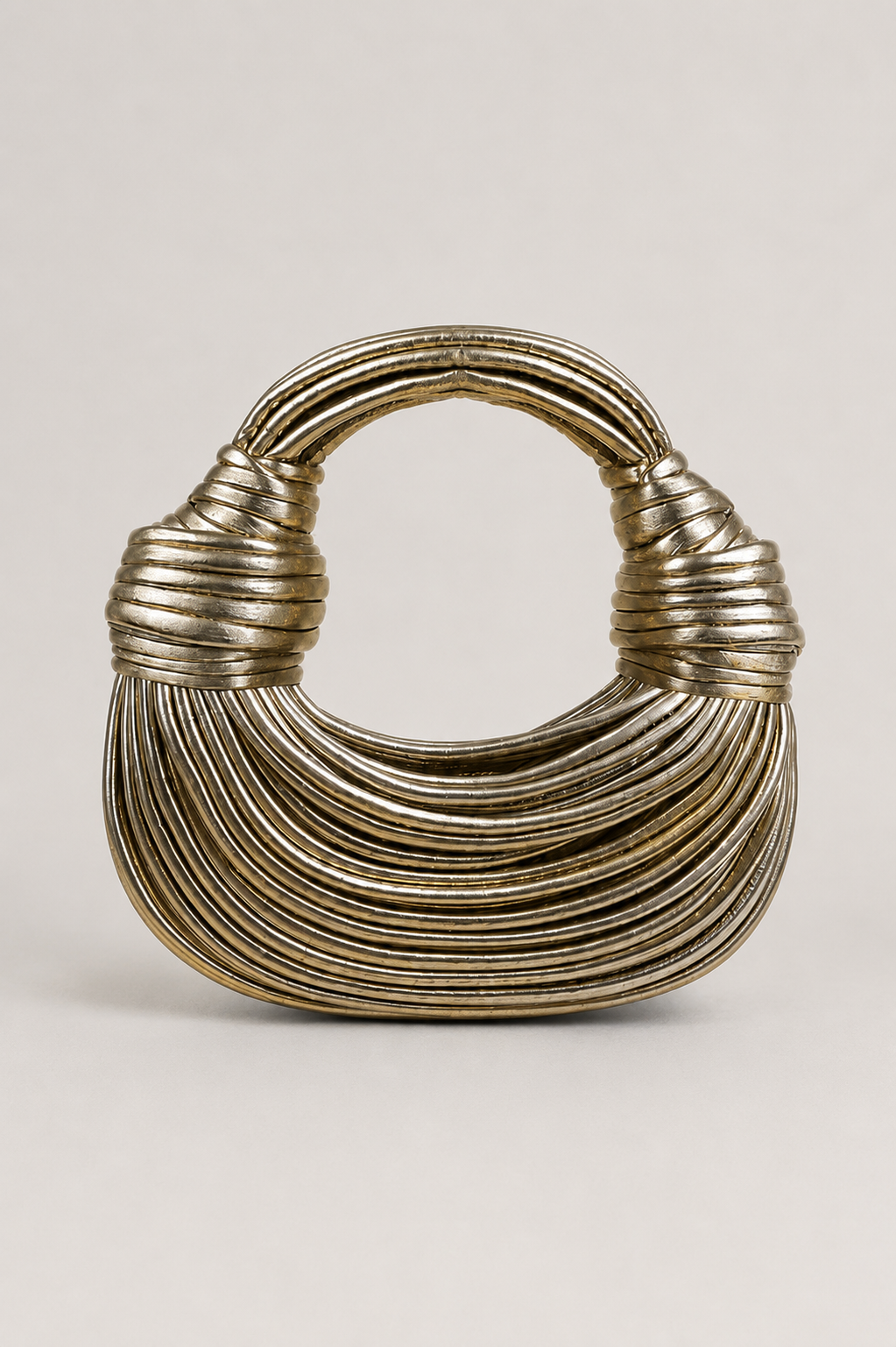 Women's sculptural coiled loop-handle crescent bag, a unique modern handbag for a chic everyday look.