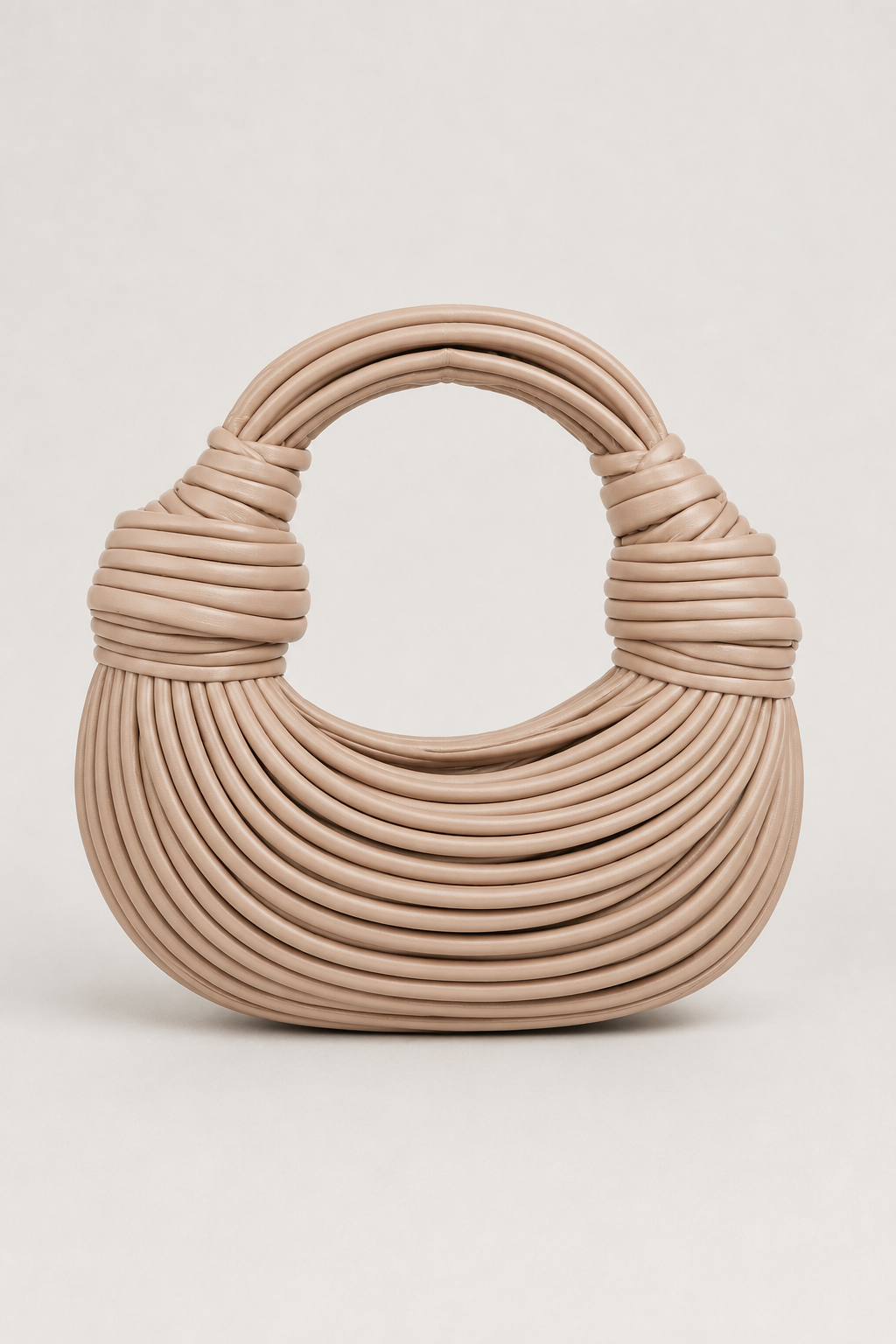 Modern crescent knot bag for women, featuring a distinctive coiled loop handle. Stylish & lightweight everyday purse.