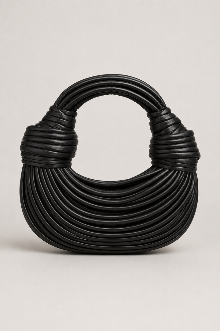 Chic fashion women's crescent bag with sculptural coiled loop handle. A unique and elegant shoulder accessory.