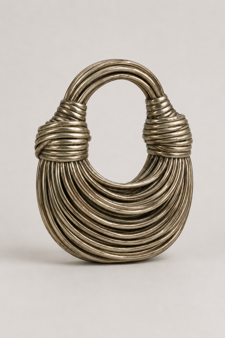 Stylish women's coiled loop-handle crescent bag. Modern, elegant shoulder purse, perfect for unique everyday fashion.