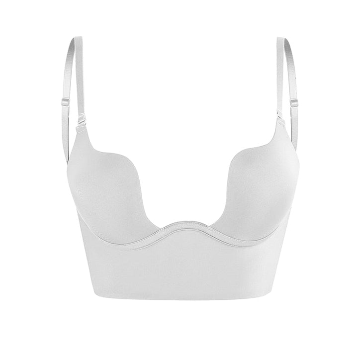 Beige seamless low back bra for women, offering comfortable and invisible support under light-colored outfits.