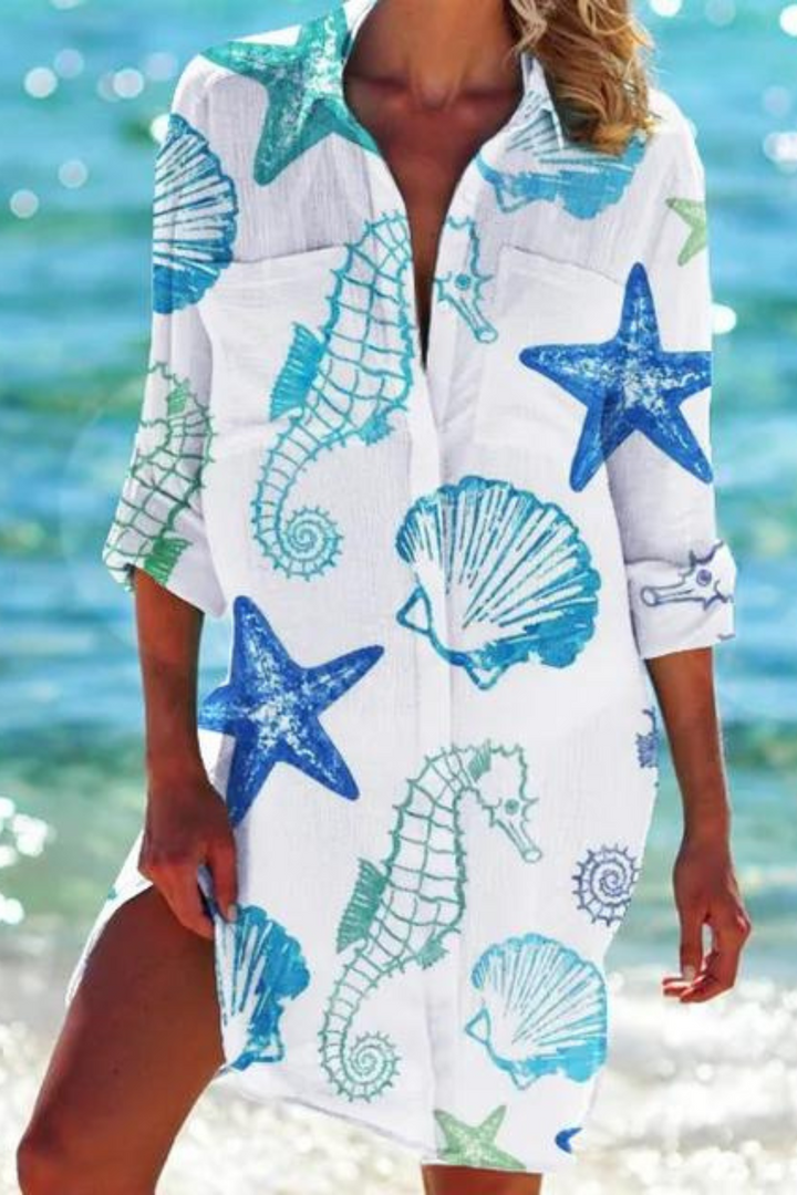 Detailed view of women's seashell & coral print button-down beach cover-up.