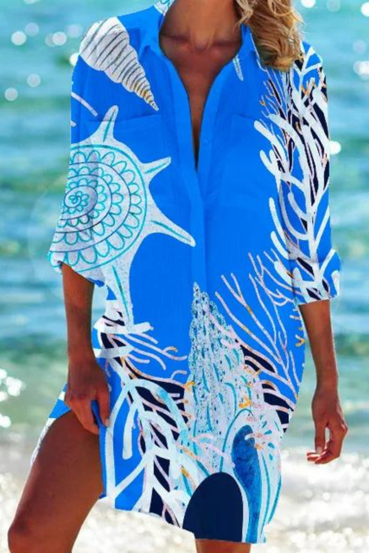 Women's long button-down beach cover-up with a lovely coral and seashell print.