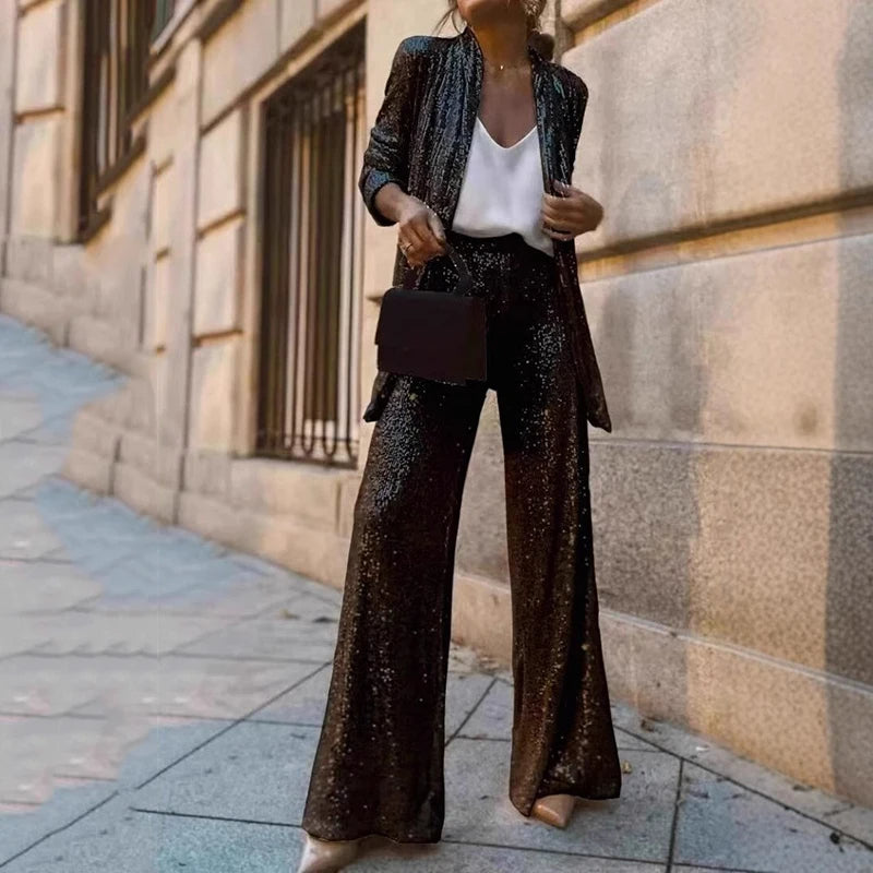 Women's shimmering sequin crop top & high-waisted wide-leg pants set. Perfect for parties & evening wear.