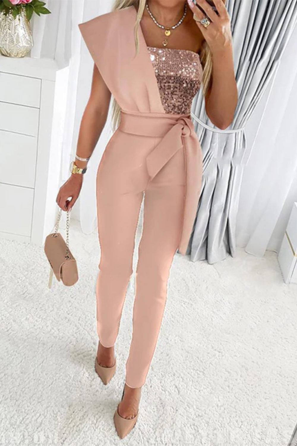 Elegant women's sequin jumpsuit with shimmering fabric, ideal for a glamorous party outfit.