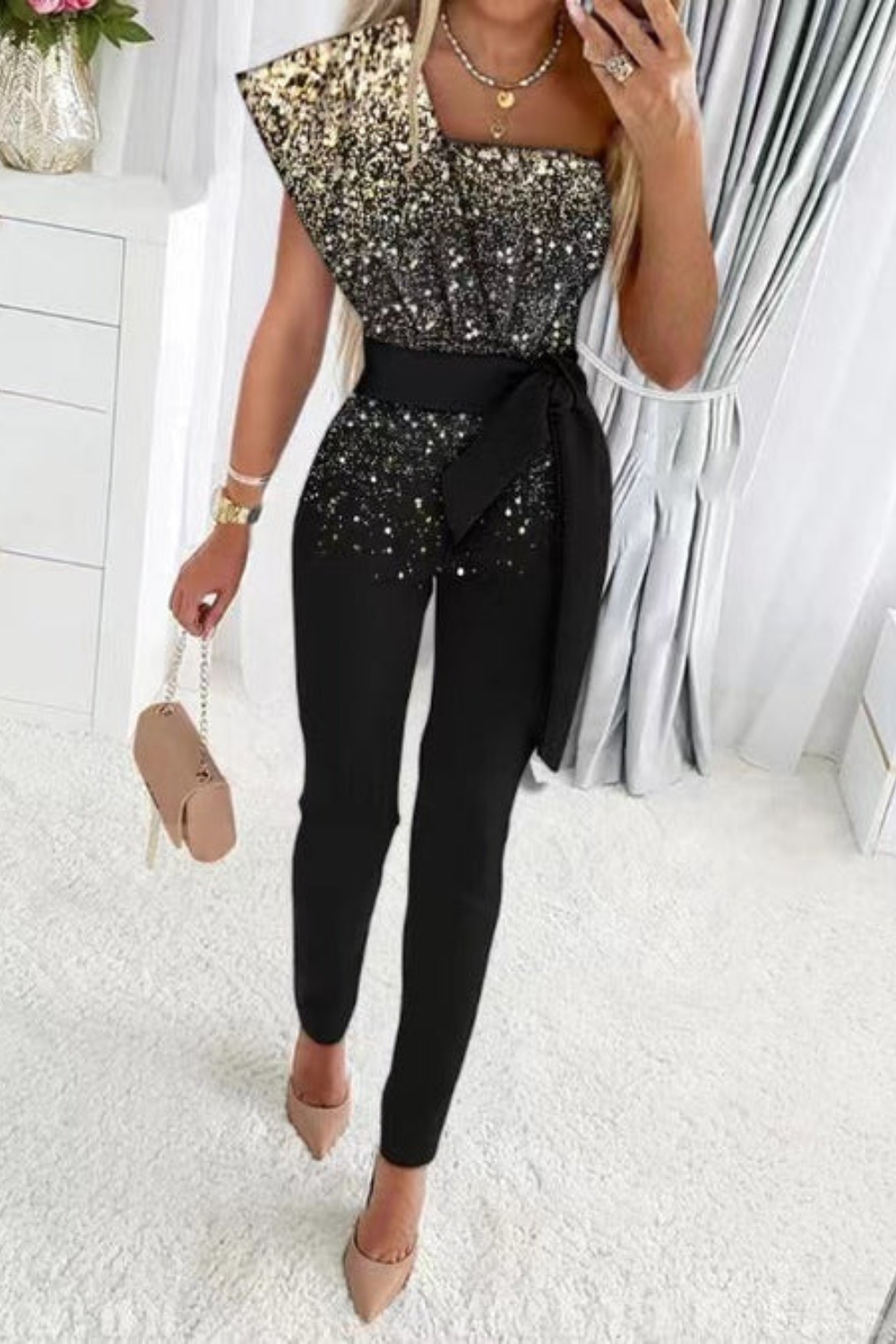 Full-length view of an elegant women's sequin jumpsuit, sparkling & perfect for any special occasion or party.