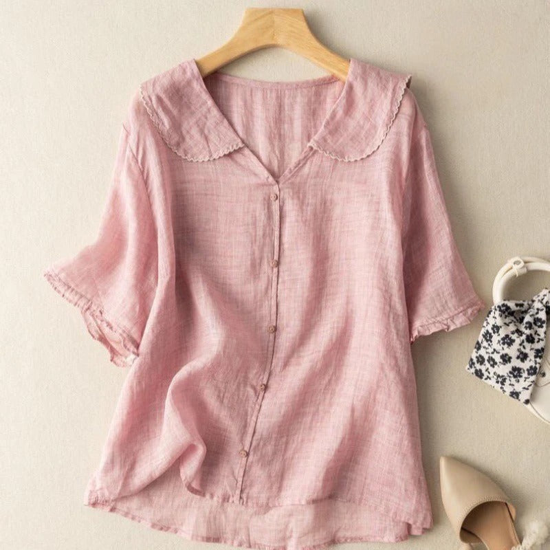 Casual women's short sleeve blouse featuring a full button front closure and unique scalloped neckline design.
