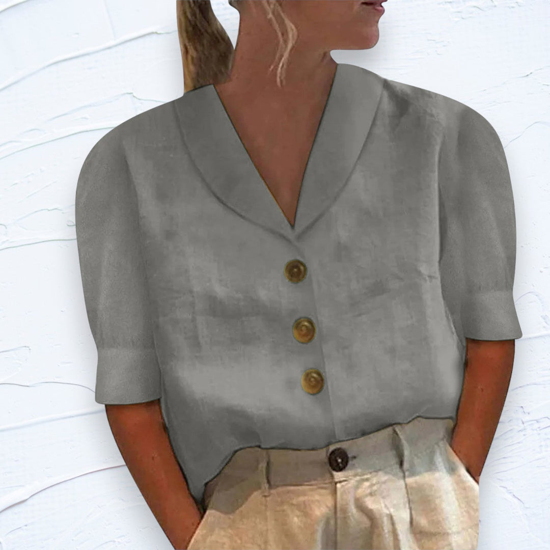 Casual women's button-front shirt with short sleeves, designed for comfort and daily wear. Versatile workwear option.
