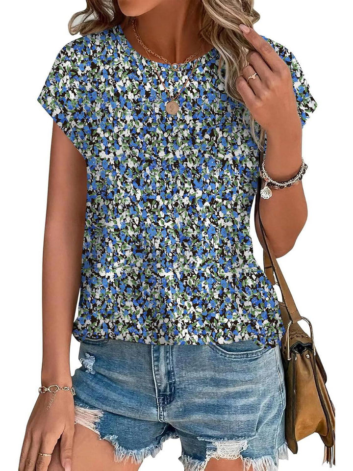 Fashionable women's top featuring a delicate leaf print. Crew neck, short sleeve casual style.