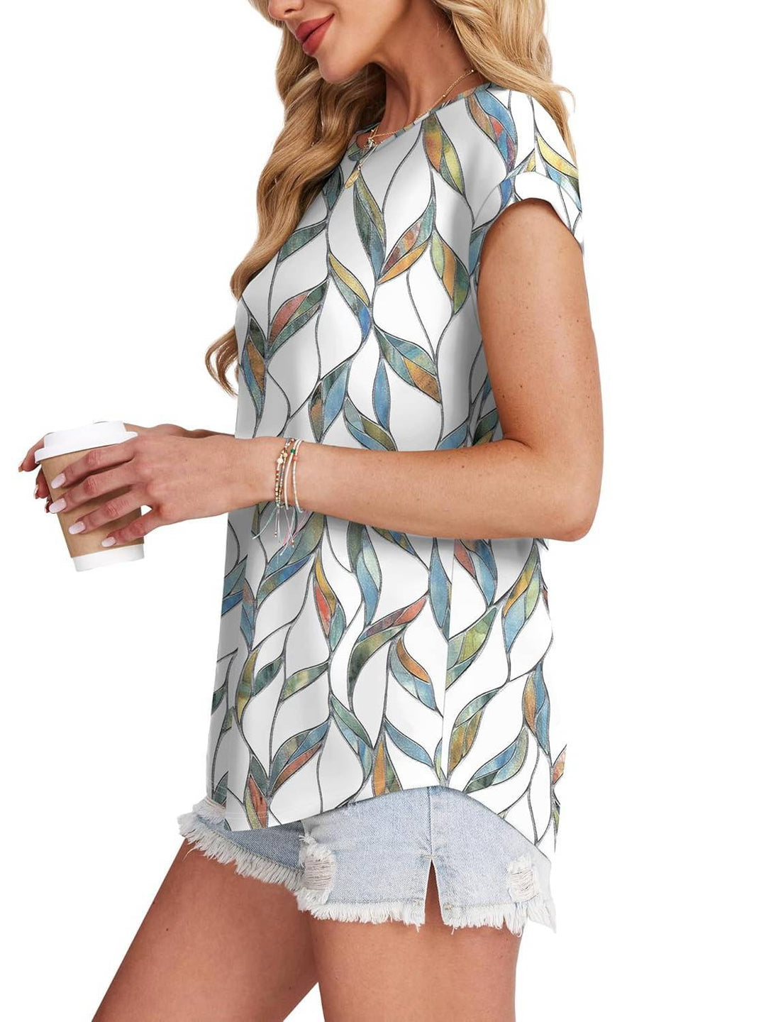 Relaxed fit women's casual top with unique leaf print. Crew neck, short sleeve design.