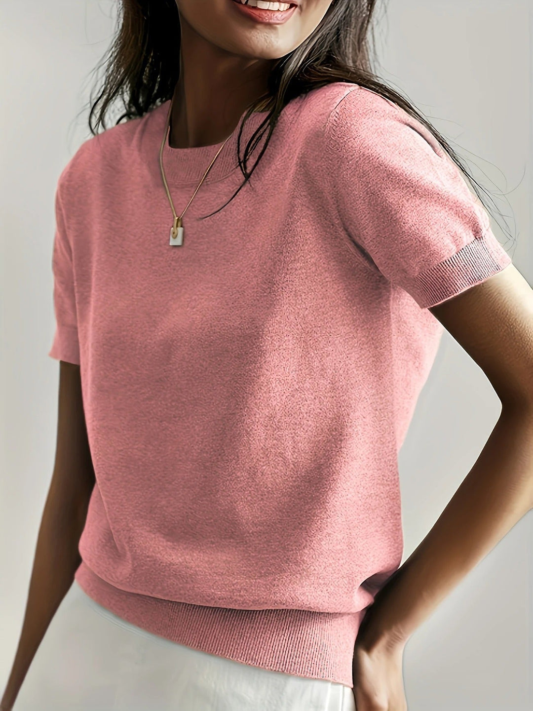 Chic women's short sleeve crew neck top with a flattering ribbed hem.