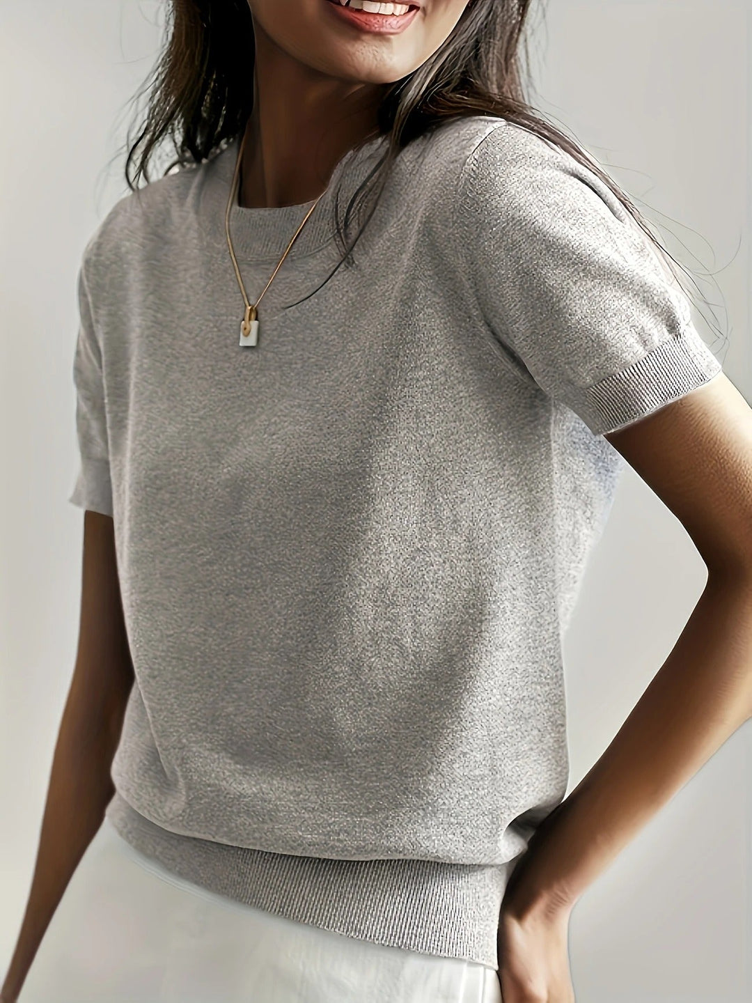 Women's casual tee with short sleeves, a crew neck, and a ribbed hem.