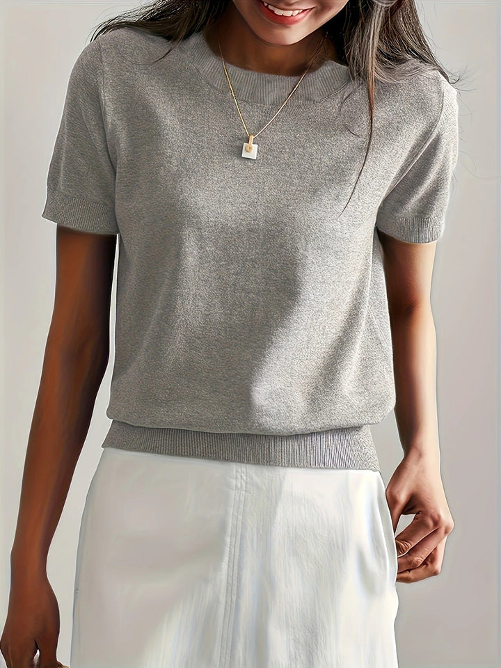 Modern women's crew neck short sleeve shirt with an elegant ribbed hem.